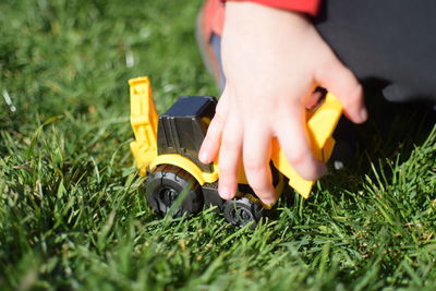 Boy playing with toy on field