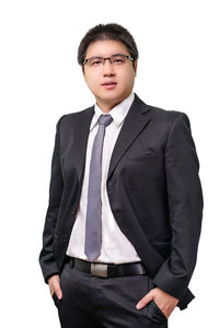 Young man standing against white background