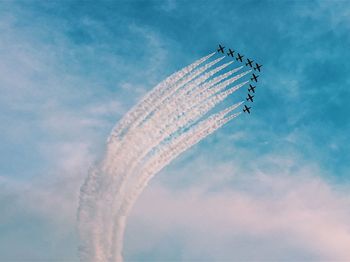 Low angle view of airplane flying against sky