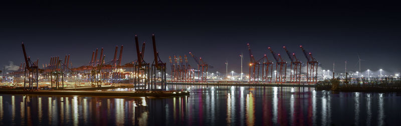 Illuminated commercial dock against clear sky at night