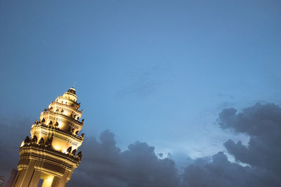 Low angle view of building against cloudy sky