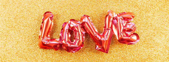 High angle view of multi colored candies on yellow background