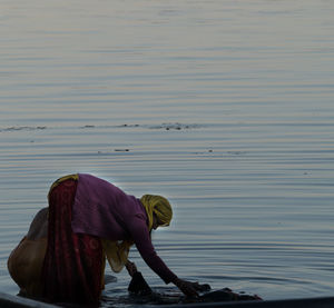 Side view of woman standing on shore