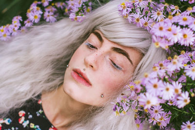 Close-up of woman by purple flowers