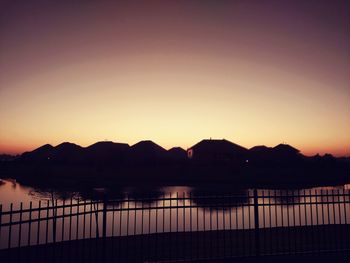 Scenic view of silhouette mountains against clear sky during sunset