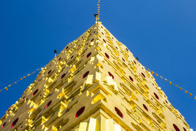 Low angle view of traditional building against clear blue sky