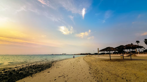 Scenic view of beach against sky during sunset