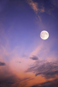 Full moon in sky with pink clouds