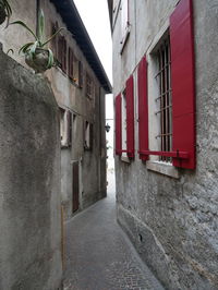 Empty alley amidst buildings in city
