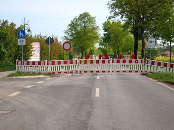 Road sign by trees