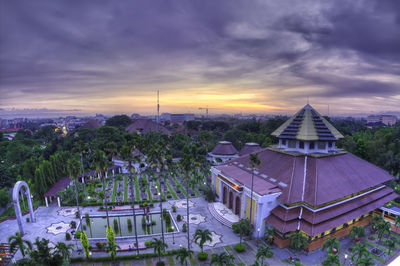 High angle view of buildings against cloudy sky