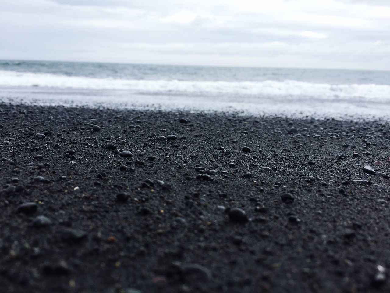 sea, horizon over water, beach, water, shore, sky, wave, scenics, sand, beauty in nature, tranquil scene, tranquility, nature, surf, surface level, idyllic, coastline, day, pebble, outdoors