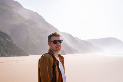 Portrait of man standing at beach 