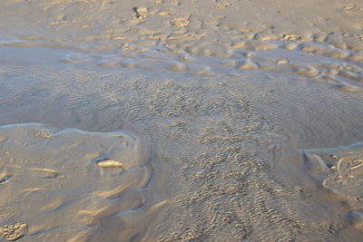 High angle view of wet sand on beach