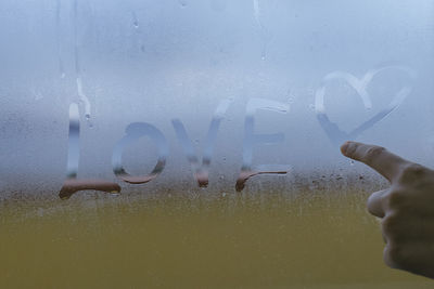 Low angle view of man standing on glass