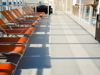 Empty chairs and tables in tiled floor