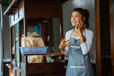 Portrait of young woman using mobile phone