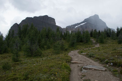 Scenic view of mountains against cloudy sky
