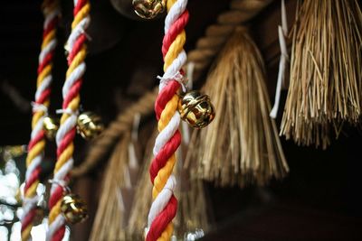 Close-up of bells on multi colored rope