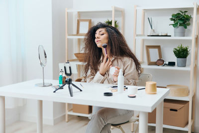 Portrait of young woman working at home