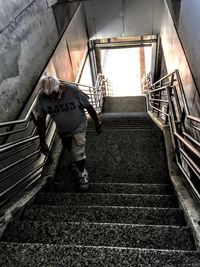 Low angle view of woman walking up stairs