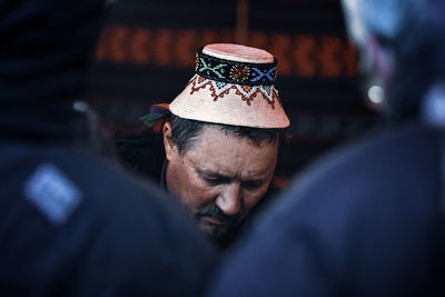 Close-up portrait of man wearing hat