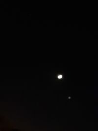 Low angle view of moon against sky at night