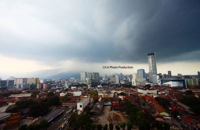 Cityscape against cloudy sky