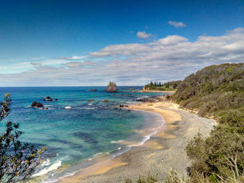 Scenic view of beach against blue sky