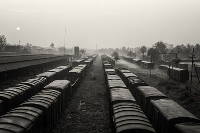 Panoramic shot of railroad tracks on field against sky