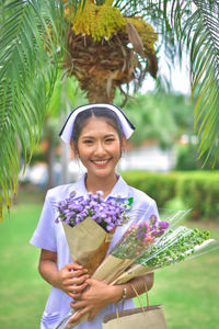 Smiling young nurse on field