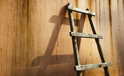 Close-up of metallic structure against wall