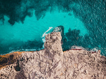 High angle view of rock formation in sea