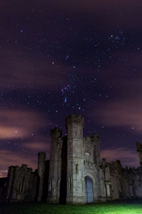 Low angle view of old building against sky at night