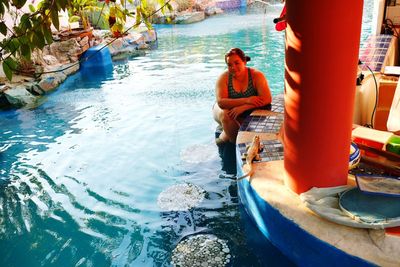 People standing by swimming pool in sea