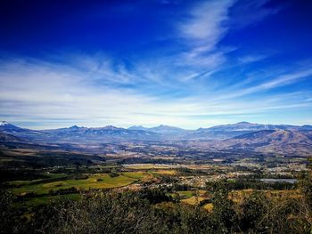 Scenic view of landscape against blue sky