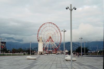 Ferris wheel at amusement park against sky