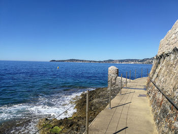 Scenic view of sea against clear blue sky