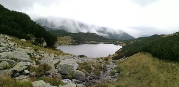 Scenic view of river amidst mountains against sky