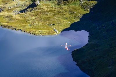 Aerial view of rescue helicopter flying over lake at snowdonia national park