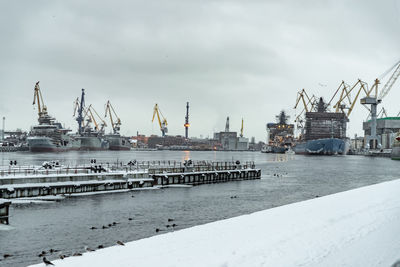 Commercial dock by sea against sky