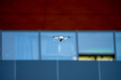 Drone flying in the air near modern building