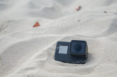 Close-up of camera on sand