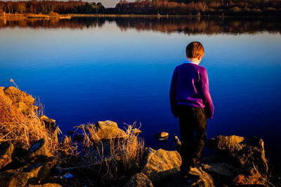 Woman standing by lake