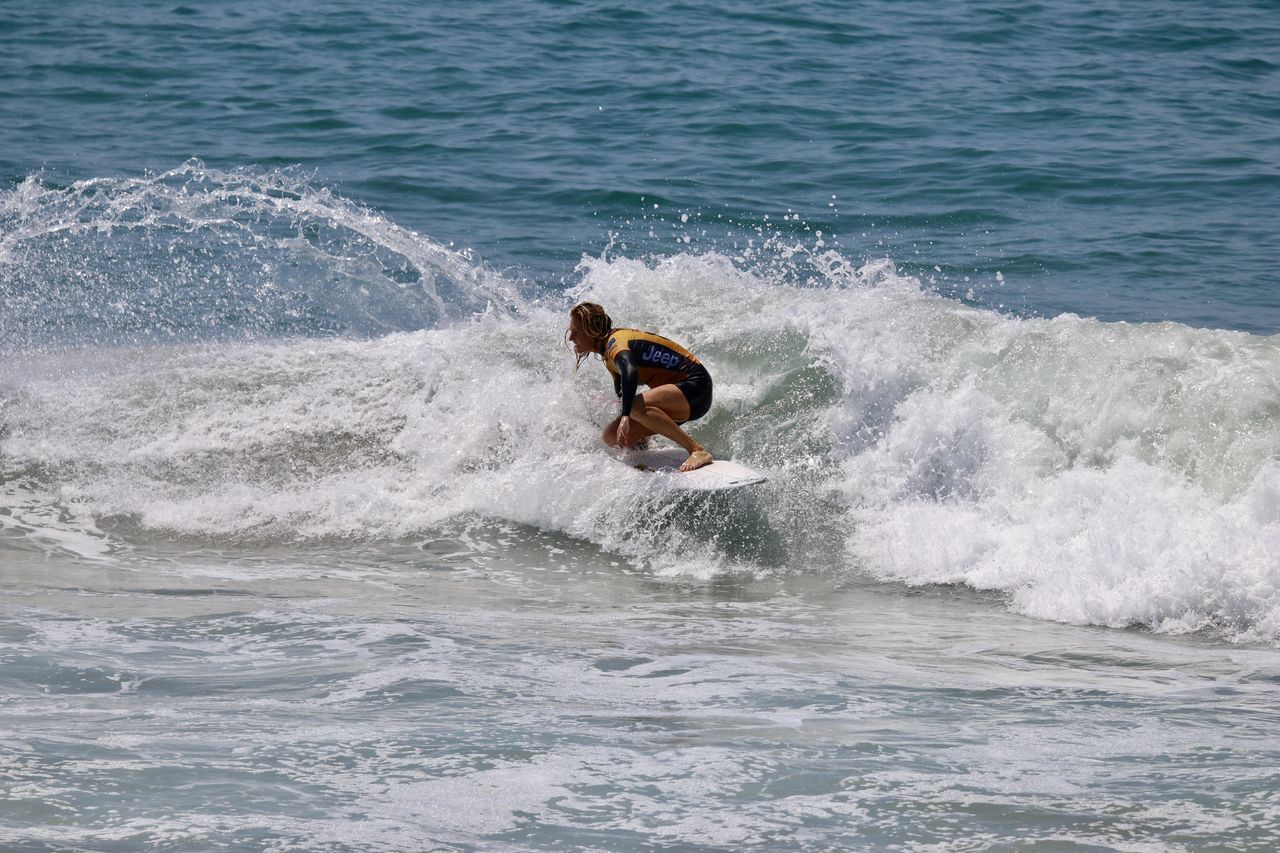 MAN SURFING ON SEA WAVES