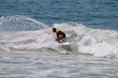 Full length of shirtless man in sea