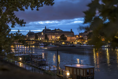 Illuminated buildings in city at waterfront