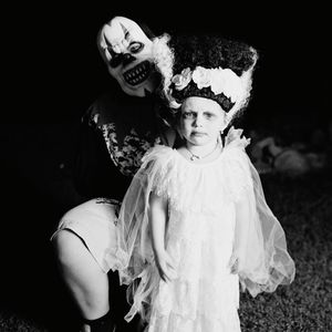 Portrait of a young girl and adult in halloween costumes