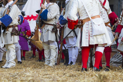 People in costume standing on hay