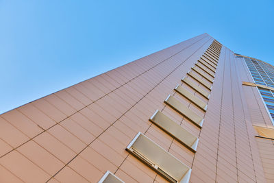 Low angle view of modern building against clear blue sky